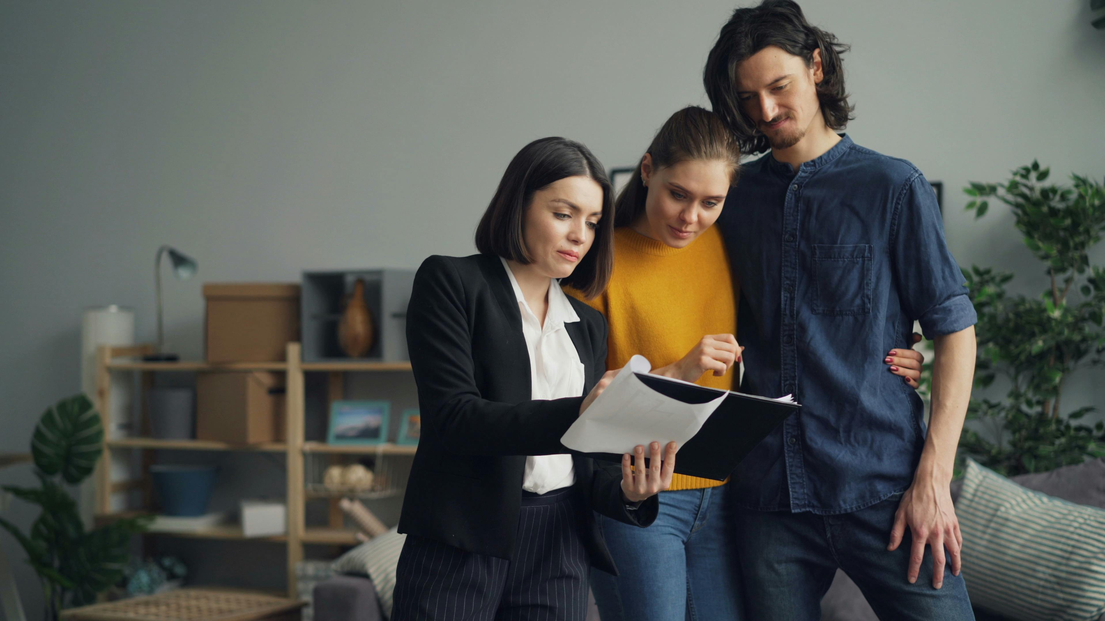 Real estate agent consulting with couple about their home purchase